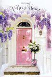 Captured outside a new home in Orpington, this tender doorway composition blends pastel charm with the promise of fresh memories. The eye is drawn first to a pale pink front door, its panels painted in a soft blush that glows gently where the light touches it, standing in pleasing contrast against the surrounding whitewashed wall. Above, wisteria tumbles in cascading swathes of lavender and light purple, the pendulous clusters forming an airy veil that arches over the entrance, reminiscent of the floral displays and climbing vines often found in nearby suburban gardens. Each strand of blossom adds to a sense of abundance and celebration, their imagined fragrance drifting down like a quiet blessing for whoever lives within. At the base of the doorway, neatly centred on the stone step, sits a vintage-style grey bucket brimming with luxurious white and cream roses. Their velvety petals are layered and full, with just the faintest ivory tint at their hearts, giving them a glowing, cloud-soft appearance. Sprigs of delicate green foliage weave around and between the blooms, introducing gentle contrast and a lived-in, garden-fresh feel, as though just arranged at Orpington Florist and delivered straight to the door. Tied around the bucket is a soft pink satin ribbon, finished in a simple bow that mirrors the colour of the door and quietly completes the design. Light filters through the wisteria canopy, creating dappled patches of brightness and shade over the flowers and threshold, lending the scene a serene, hopeful mood. It feels perfectly suited to a congratulations-on-your-new-home bouquet in Orpington, waiting patiently to be lifted inside and placed where it can fill each room with beauty, fragrance, and a sense of welcome.